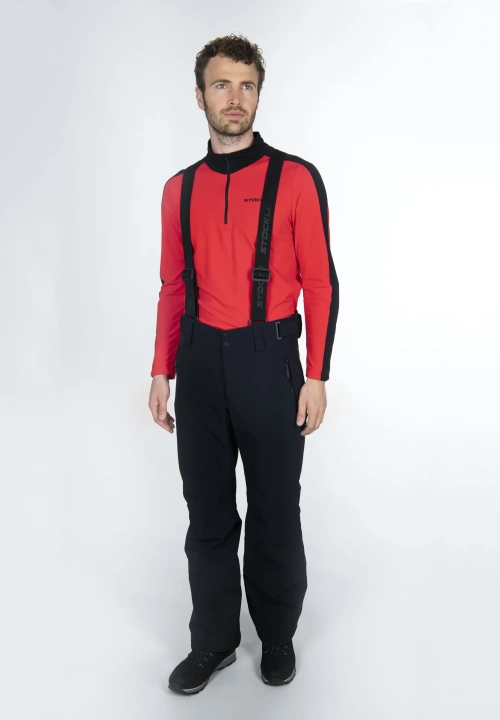 Model w spodniach STOECKLI SKI PANT RACE BLACK LONG i kurtce, ujęcie z przodu prezentujące pełną sylwetkę.