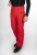 Model w czerwonych spodniach STOECKLI SKI PANT RACE RED i czarnej kurtce, ujęcie na nogi i buty.
