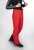 Model w czerwonych spodniach STOECKLI SKI PANT RACE RED, ujęcie 3/4 na nogi.