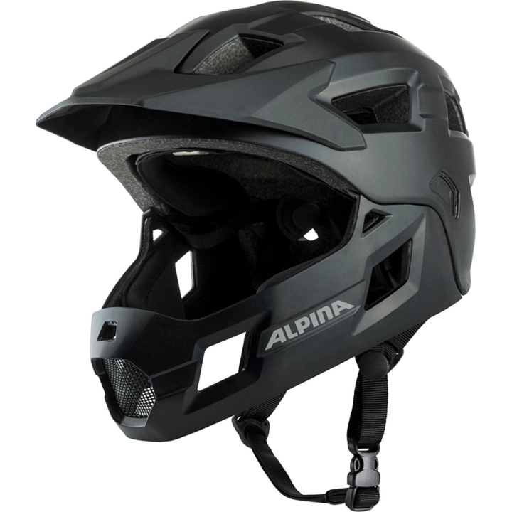 Czarny kask rowerowy z odpinaną szczęką dla dzieci ALPINA RUPI Black Matt ujęty pod kątem 3/4, z widocznymi paskami zapięcia Ergomatic i profilowaną konstrukcją Inmold.